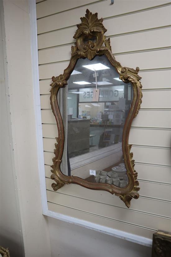 An 18th century style carved giltwood rococo wall mirror, 59 x 104cm